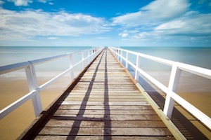 Long white pier and ocean