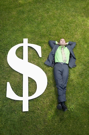 Man laying on grass with sign