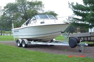 boat in dirt driveway